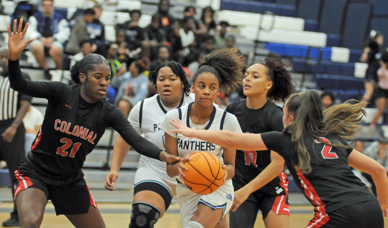 Dr. Phillips freshman guard Kendall Perry drives the lane and draws Colonial defenders Breanne Eccleston (21), Carmen Richardson (10) and Sophya Barreiro (2) during the second quarter of their nondistrict game Wednesday. Perry had 13 points, and Richardson had 12 points.